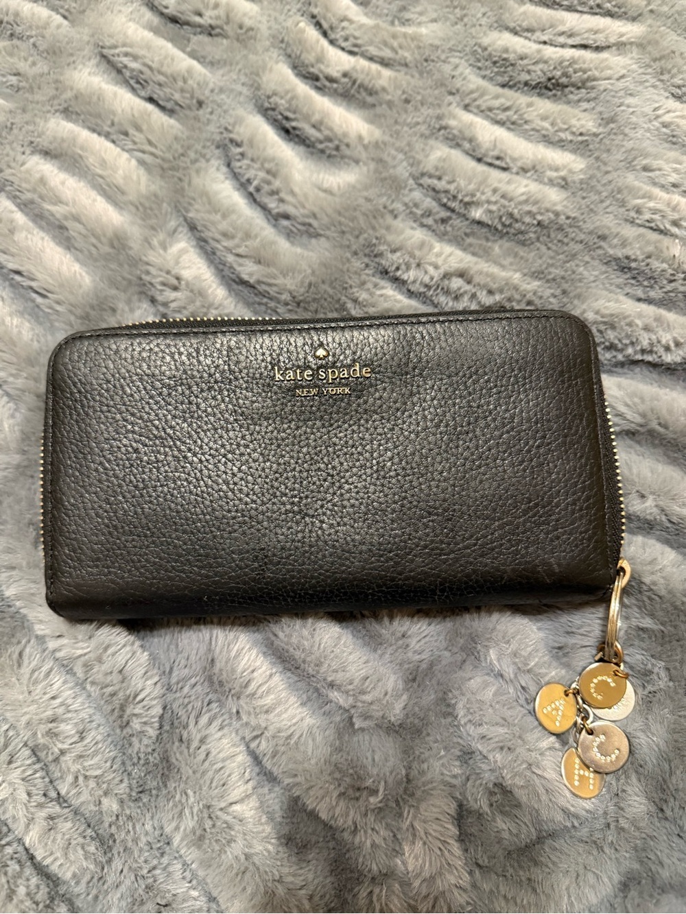 kate spade black pebbled leather zip-around wallet with gold charm